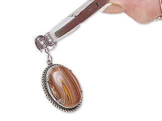 flat nylon-jaw pliers gripping spiral on cabochon setting